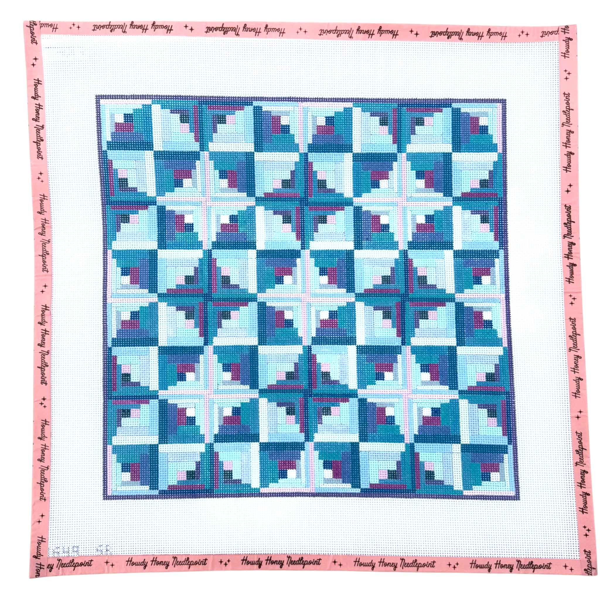 Quilt with blue and white geometric pattern on a white background
