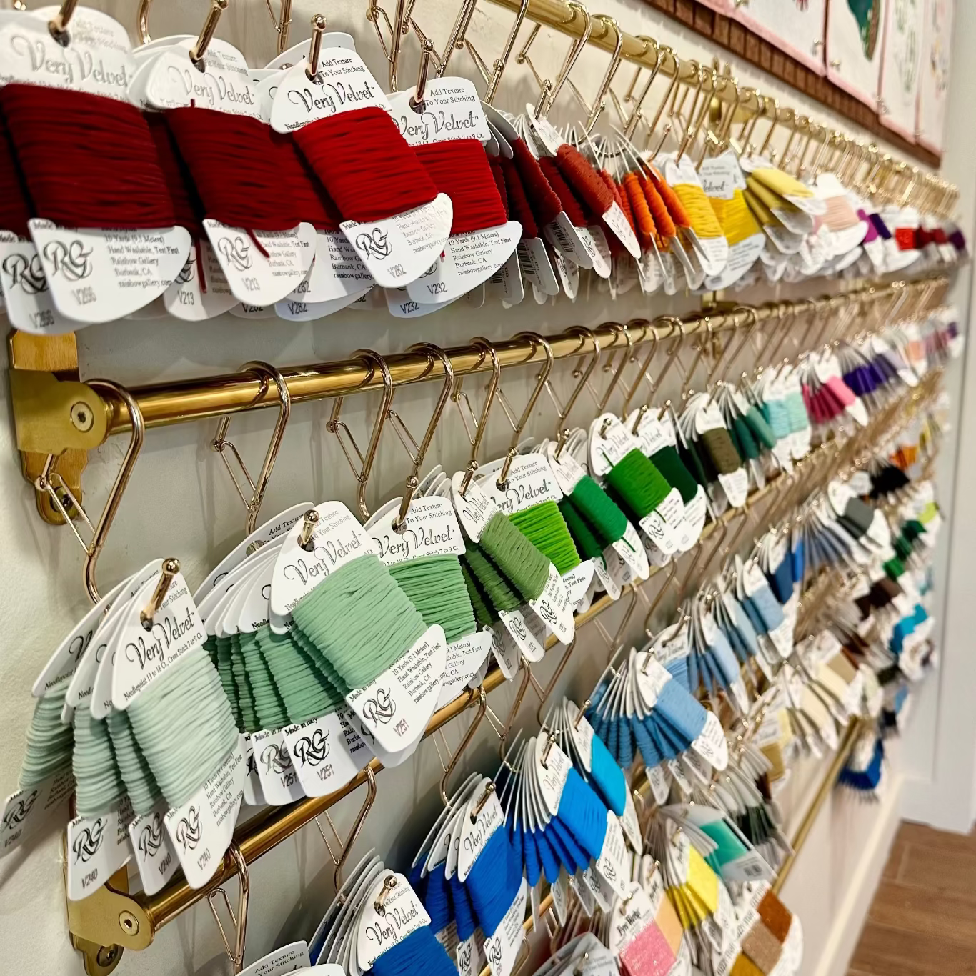 Colorful thread spools on a rack in a store setting