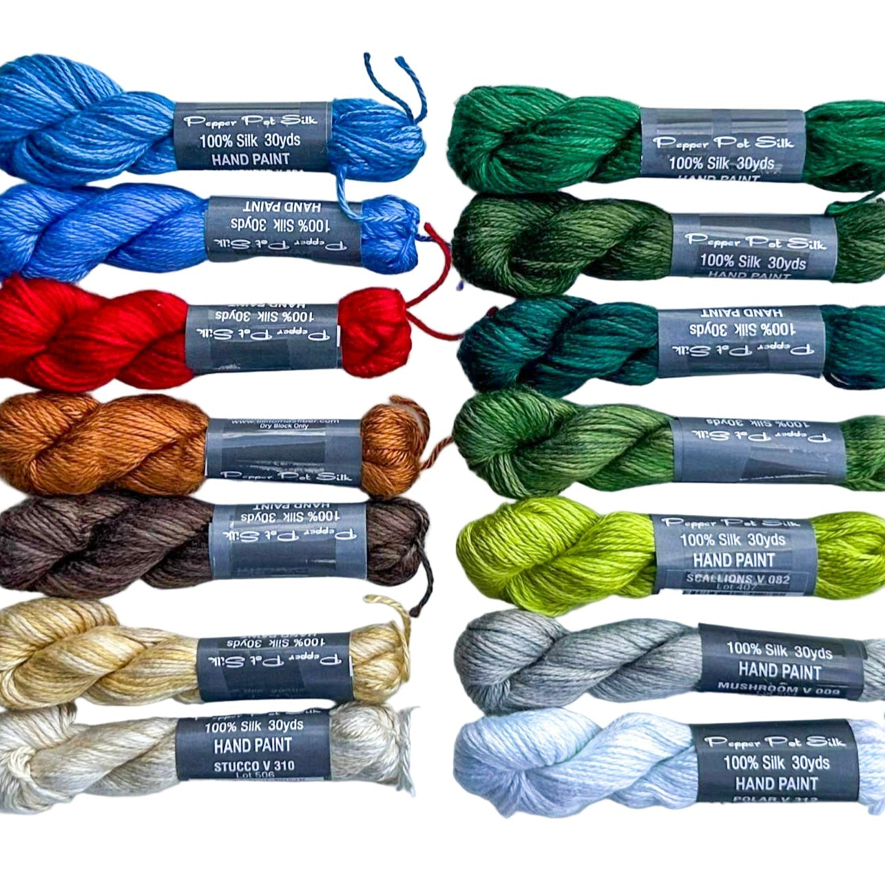 Assorted skeins of yarn in various colors on a white background