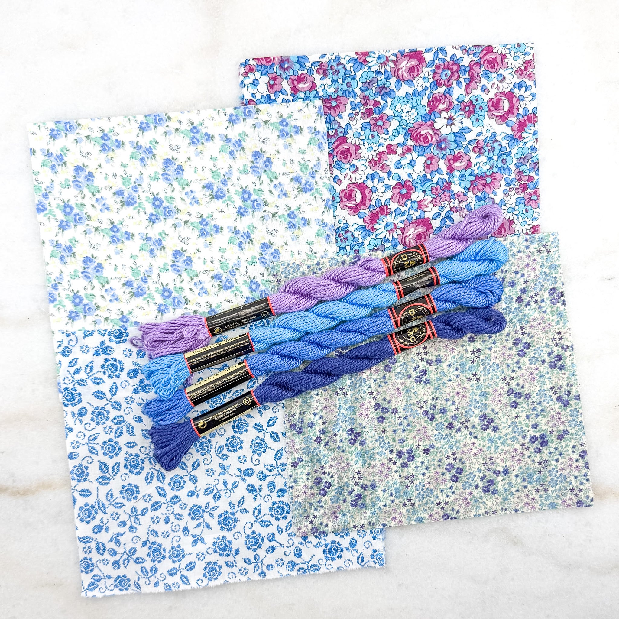 Embroidery floss with colorful braids on floral-patterned fabric