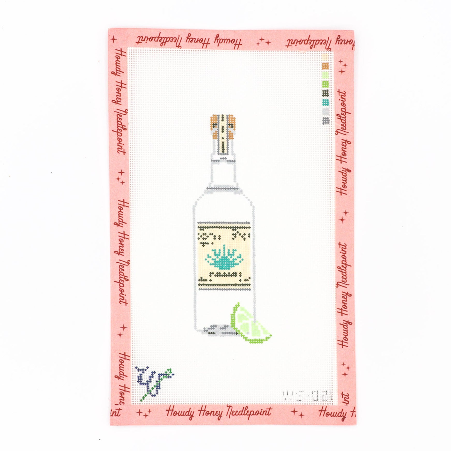 Needlecraft canvas with a design of a bottle of tequila, lime, and salt on a pink background, includes a tapestry needle.