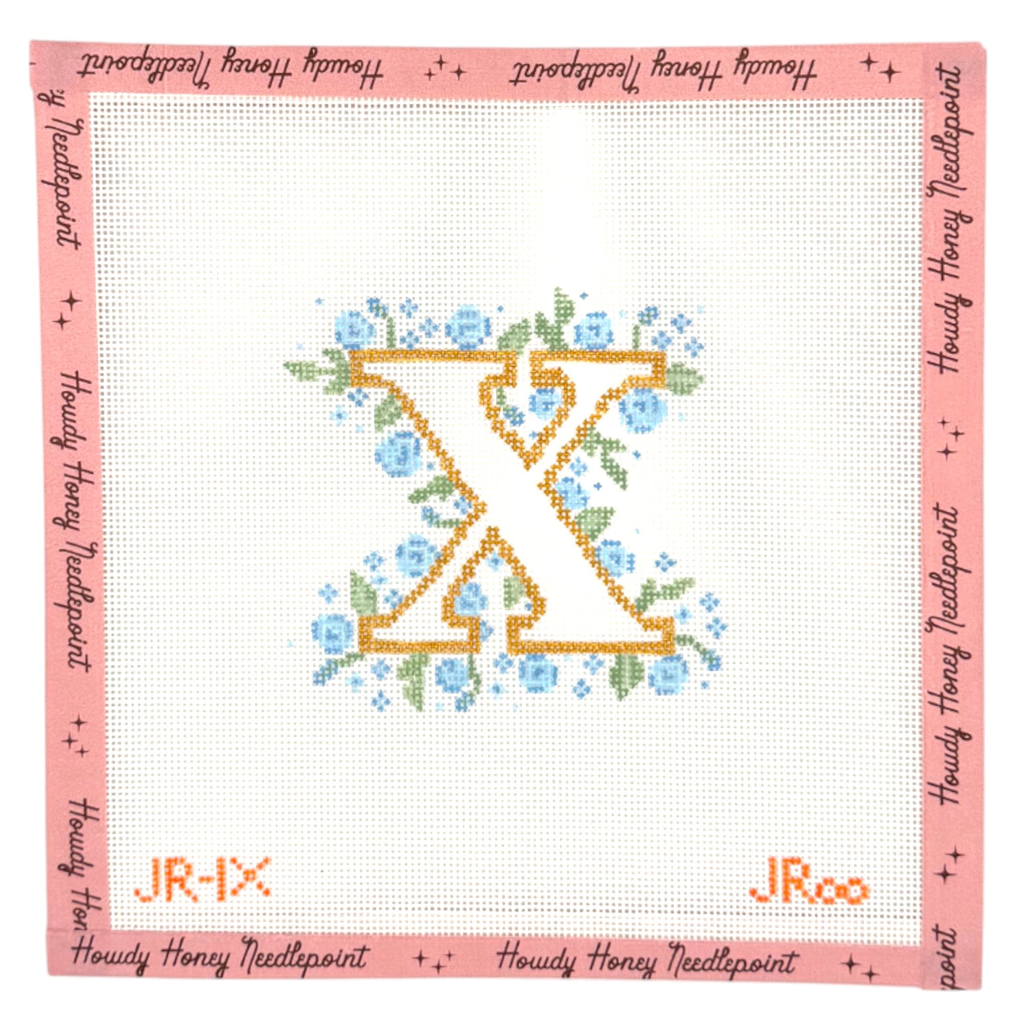 Cross-stitched letter 'K' with flowers on a white background, framed by pink border with text.