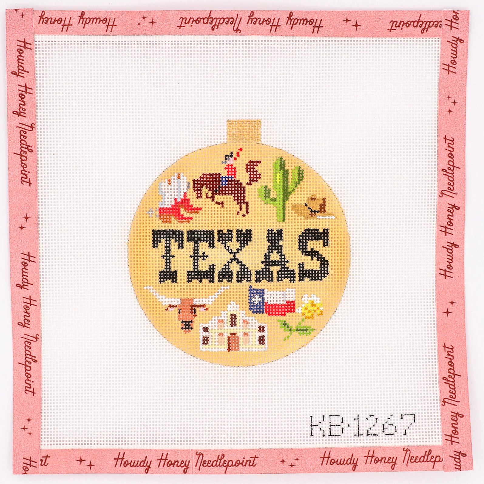 Hand-painted needlecraft canvas with a circular design featuring the word 'TEXAS' and state-related imagery, bordered by a pink edge with text.