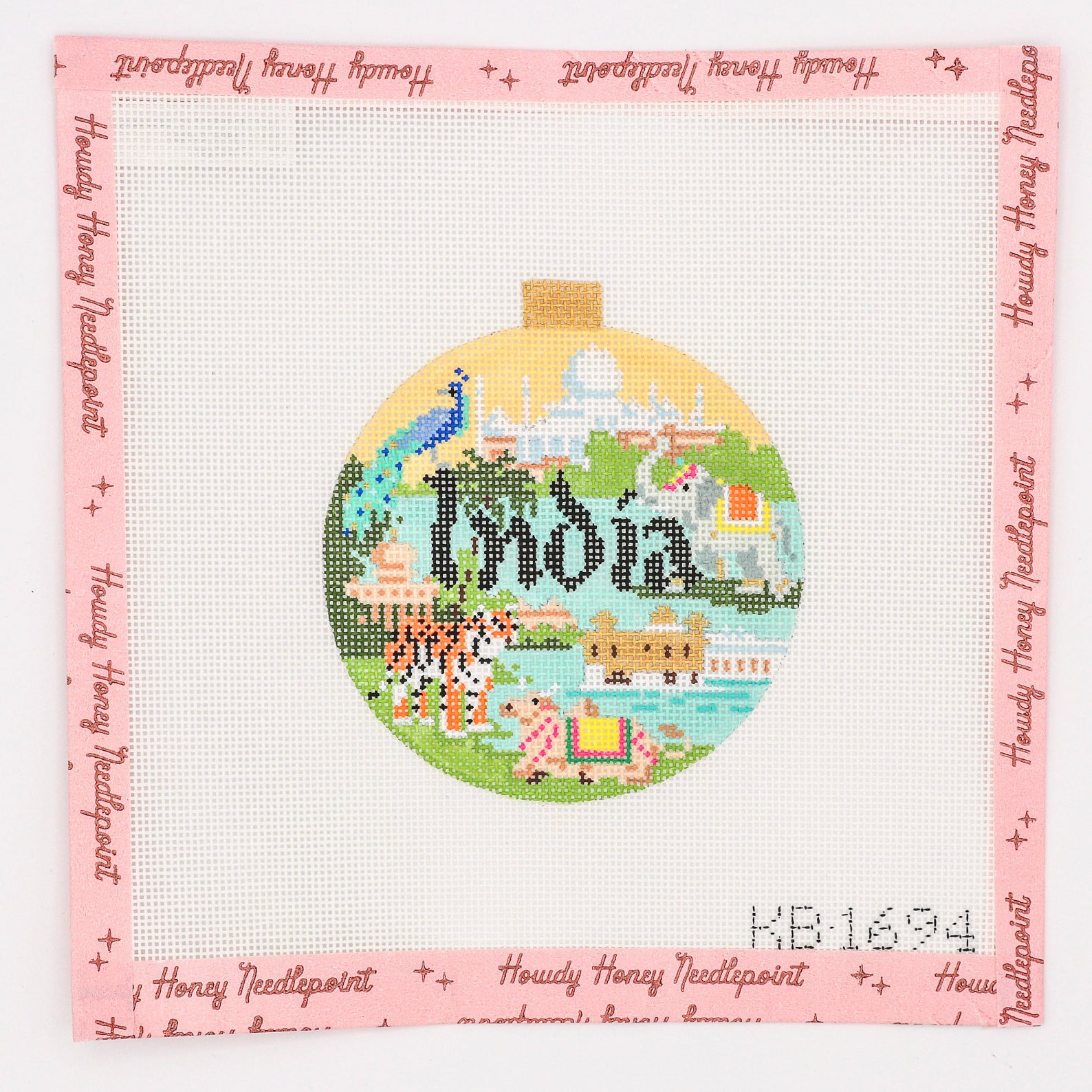 Hand-painted round canvas with a travel theme, featuring the word 'India' and iconic Indian imagery, surrounded by a pink border with decorative details.