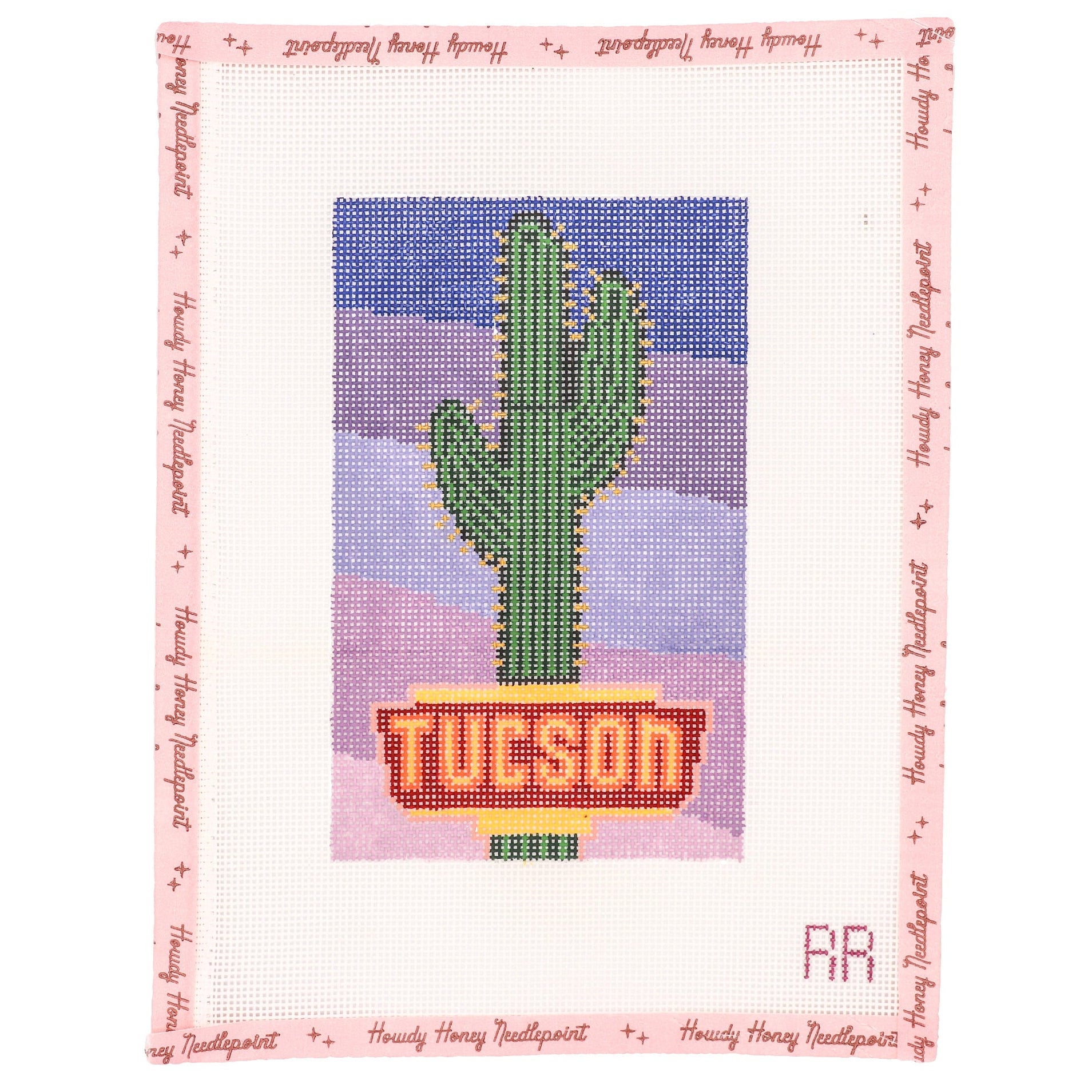 Cross-stitched design of a cactus with 'Tucson' on a pink border, featuring text.