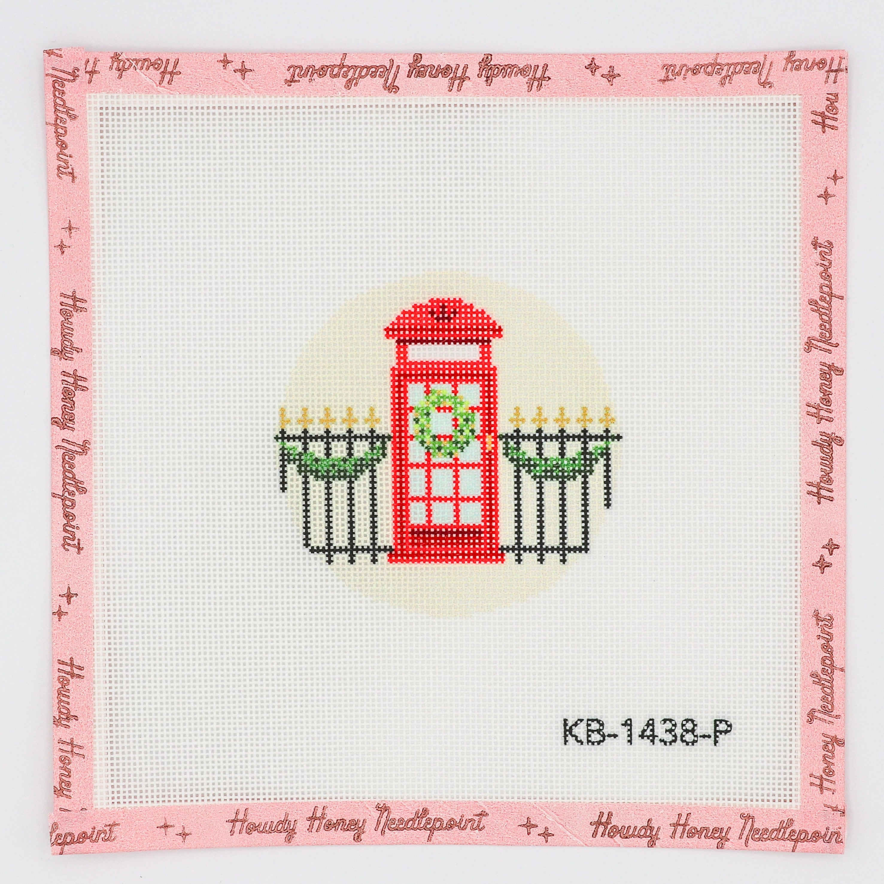 A hand-painted needlecraft canvas with a design of a red telephone box in front of a pink fence, labeled 'KB-1438-P'.