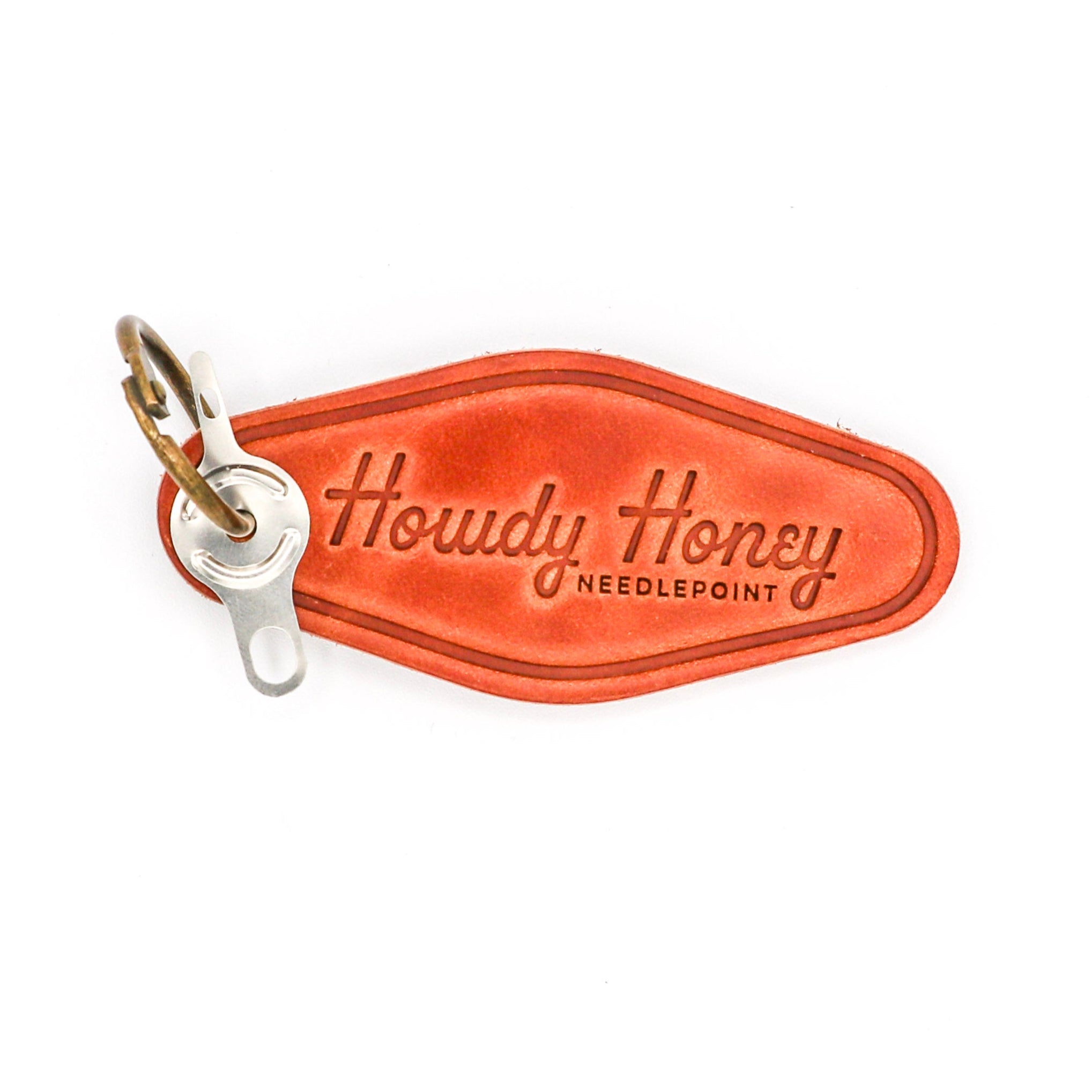 Brown leather key tag with 'Howdy Honey' branding on a white background
