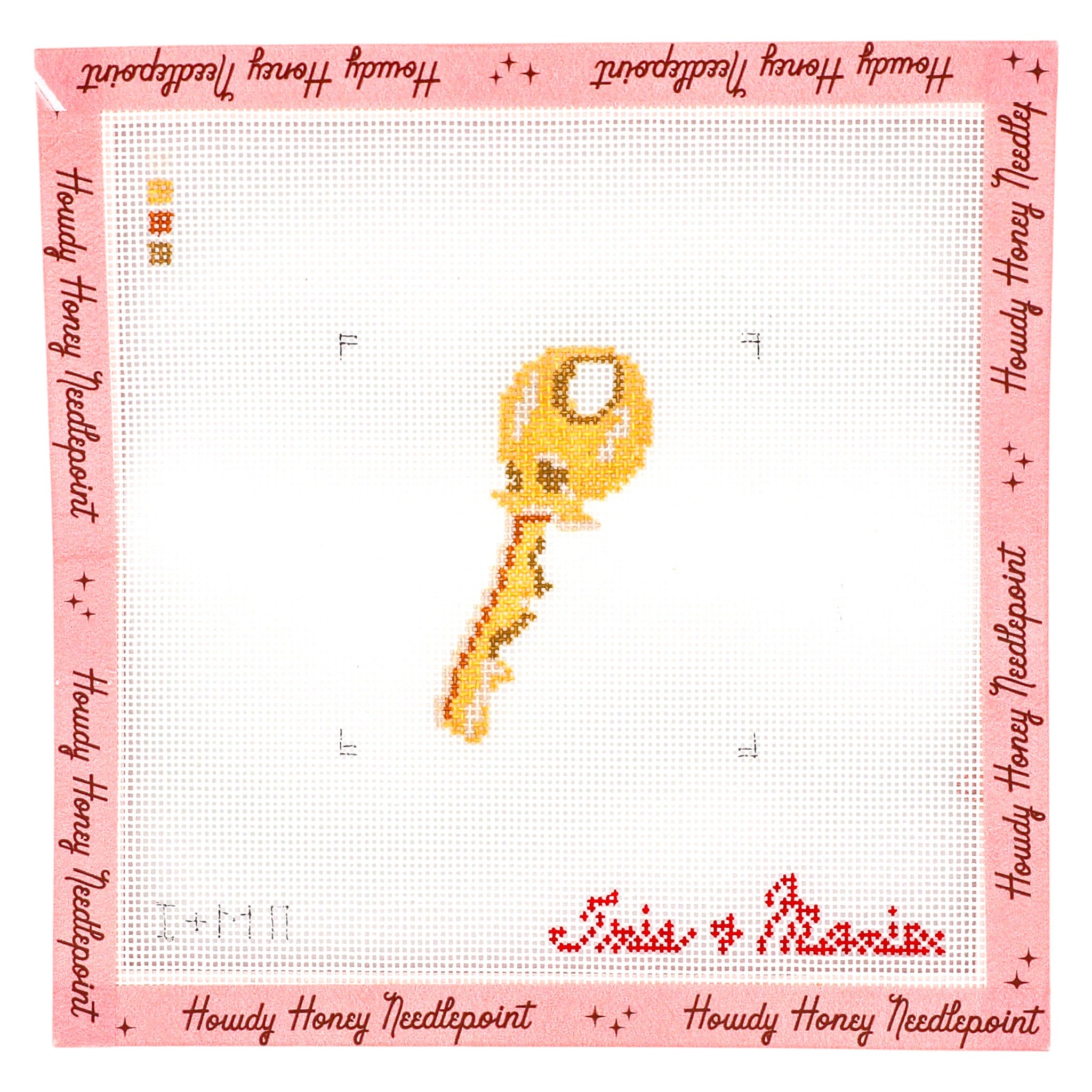 Cross-stitched design of a key on a white fabric with pink border and text, featuring 'Howdy Honey Needlepoint'.