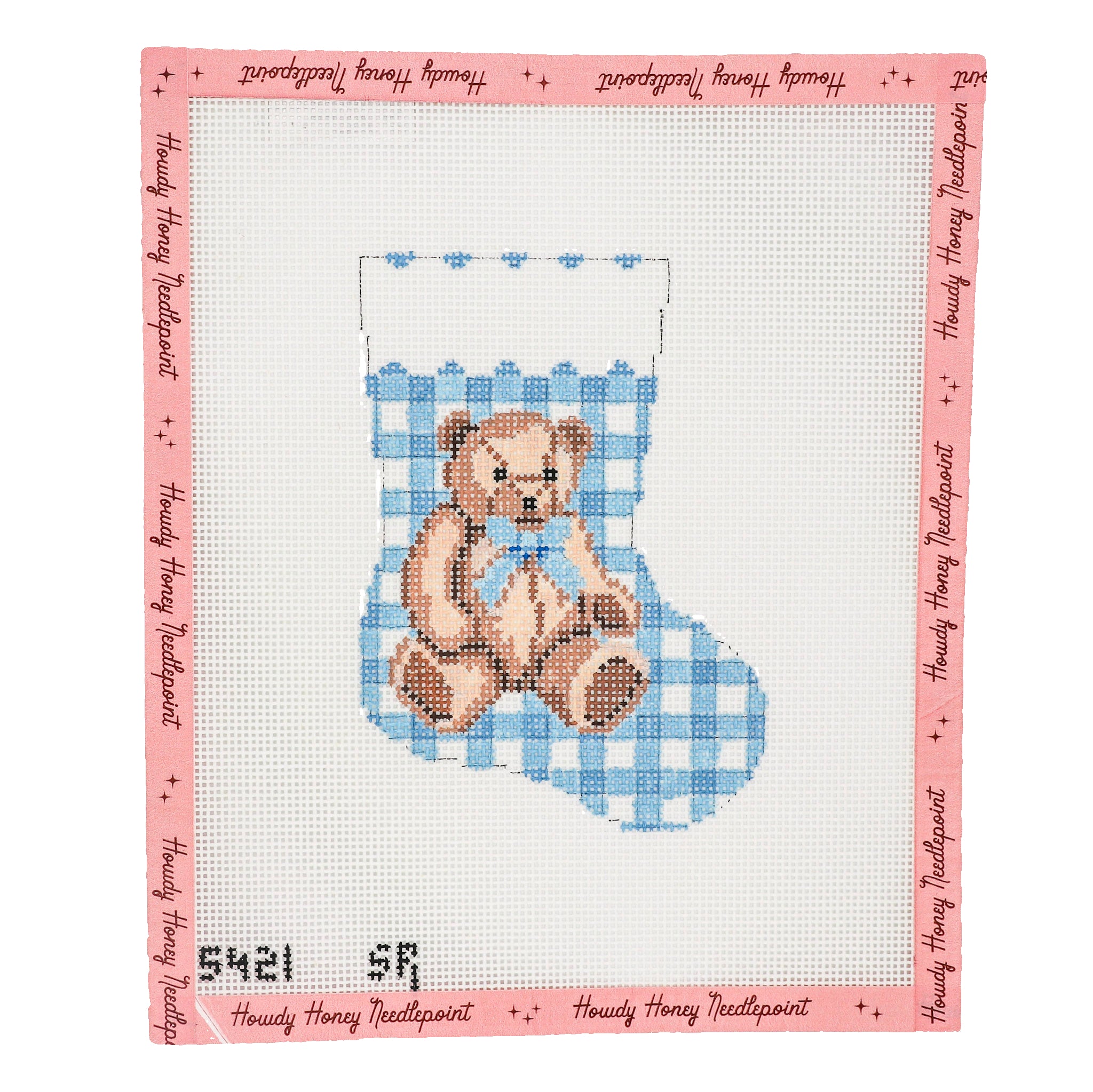 Cross-stitched design of a teddy bear in a blue chair on a white background with pink border.
