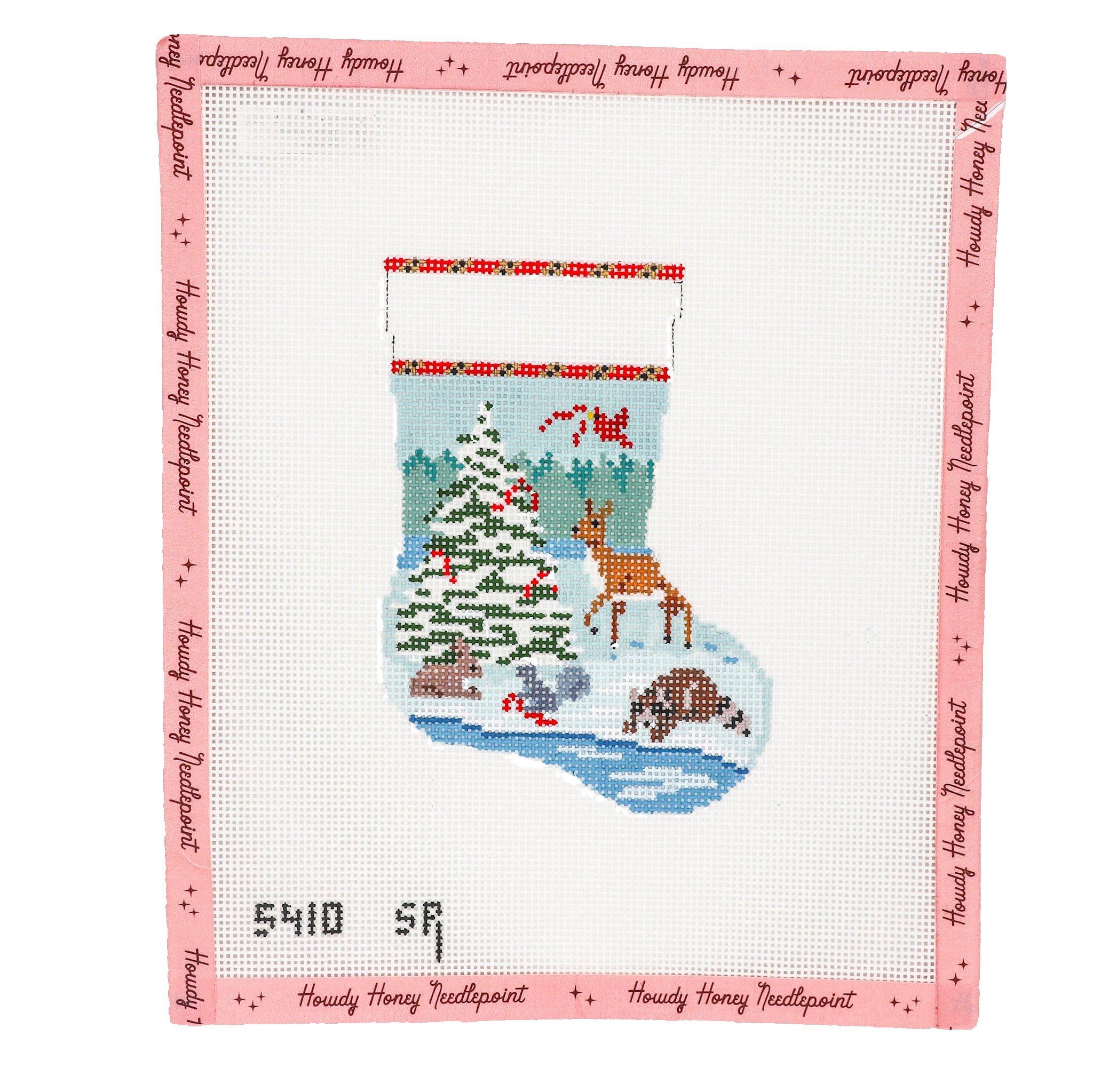 Cross-stitched design of a Christmas stocking with a tree, deer, and other elements on a white background.