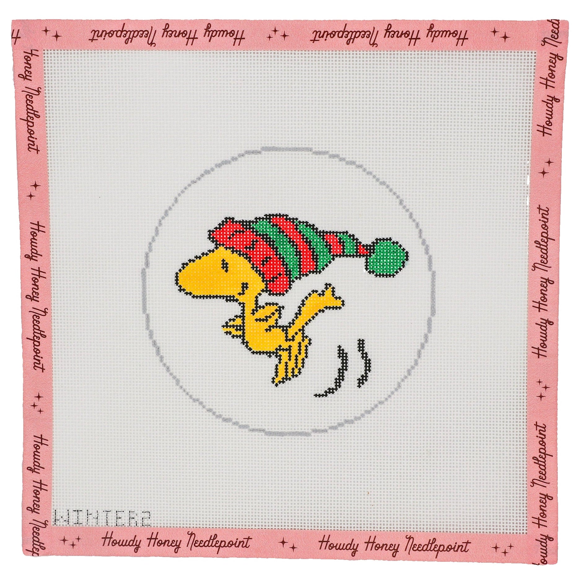Cross-stitched design of a yellow bird in a red and green hat on a white background with pink border and text.