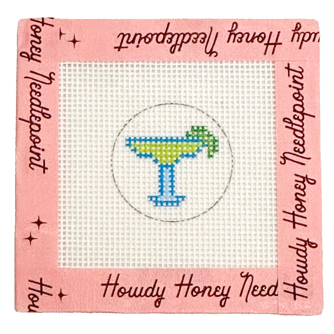 Cross-stitched margarita design on a pink fabric with 'Howdy Honey Needlepoint' branding.
