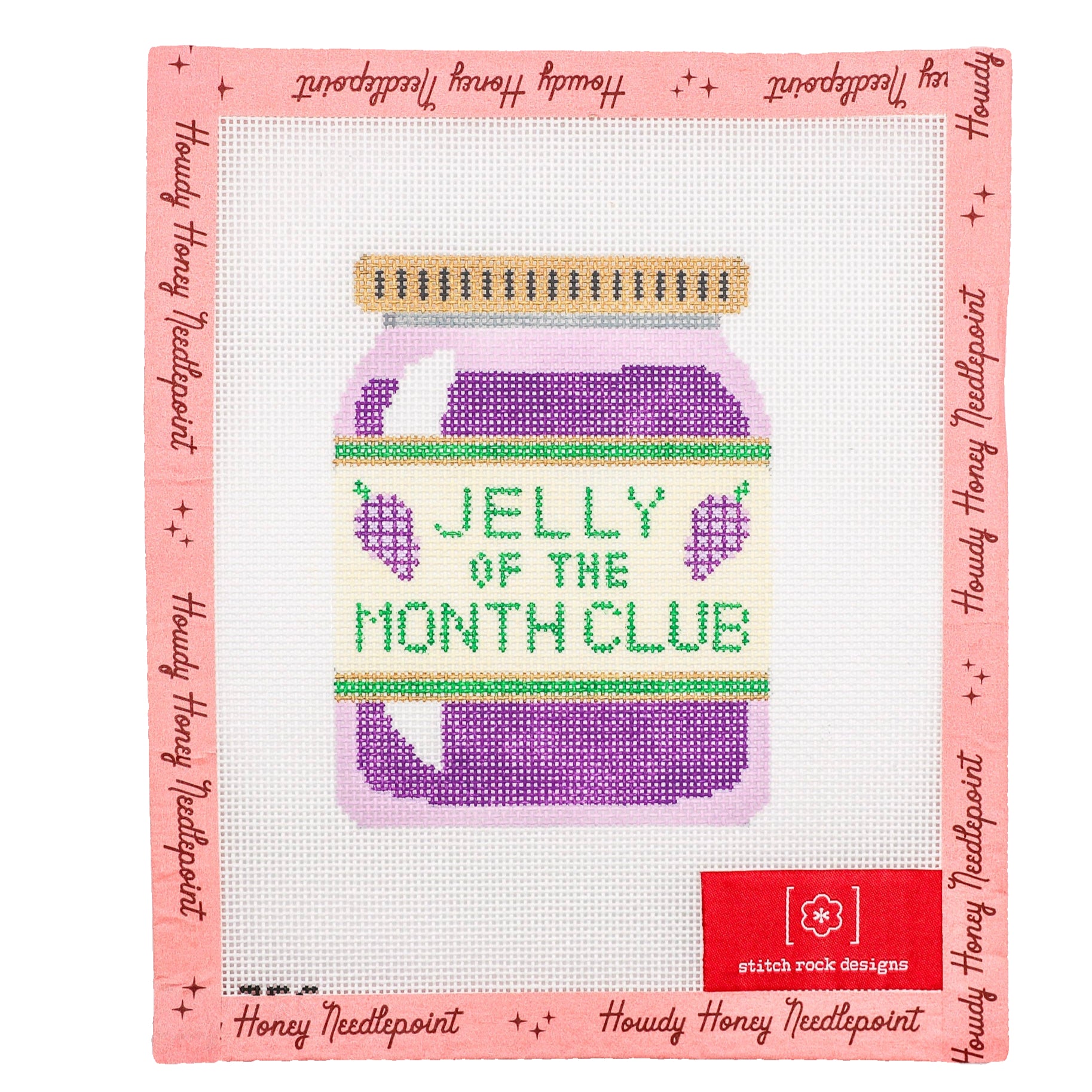 A needlecraft kit depicting a jar labeled 'JELLY OF THE MONTH CLUB' with purple grapes, surrounded by a pink border with text.