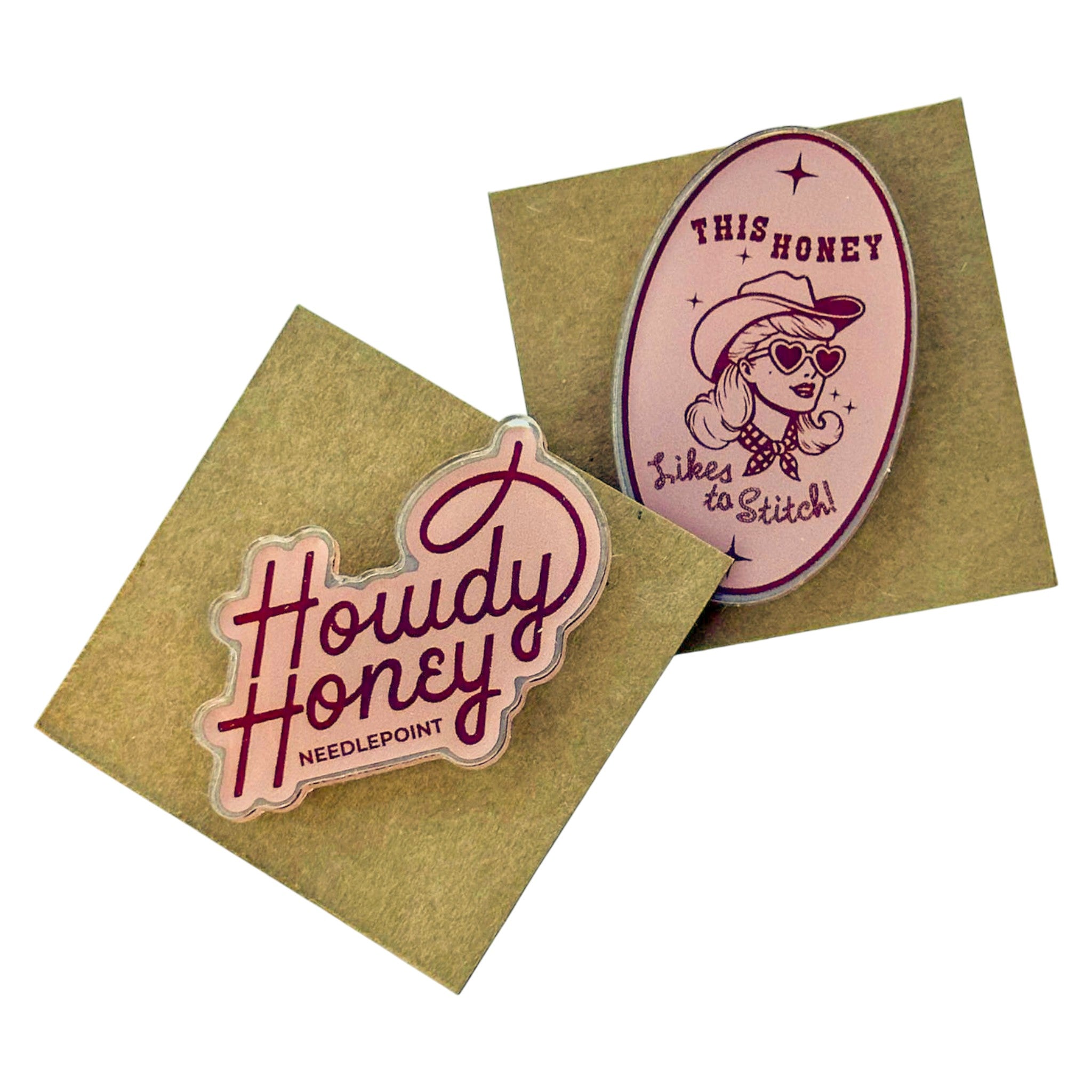 Two needlepoint stickers on kraft paper with 'Howdy Honey' and 'This Honey Likes to Stitch!' designs.